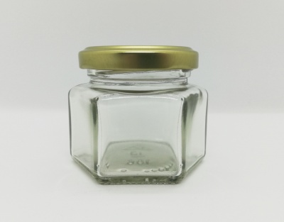 Frasco de vidro hexagonal com tampa dourada