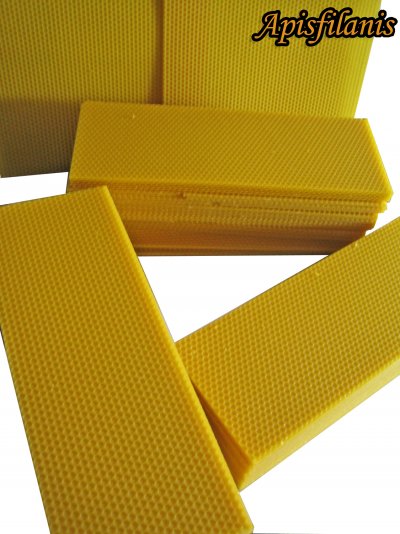 Placas amarelas de cera com padrão hexagonal e texto Apisfilanis