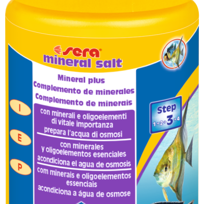 Frasco amarelo com rótulo azul e amarelo, suplemento mineral para aquários com texto multilíngue e imagens de peixes
