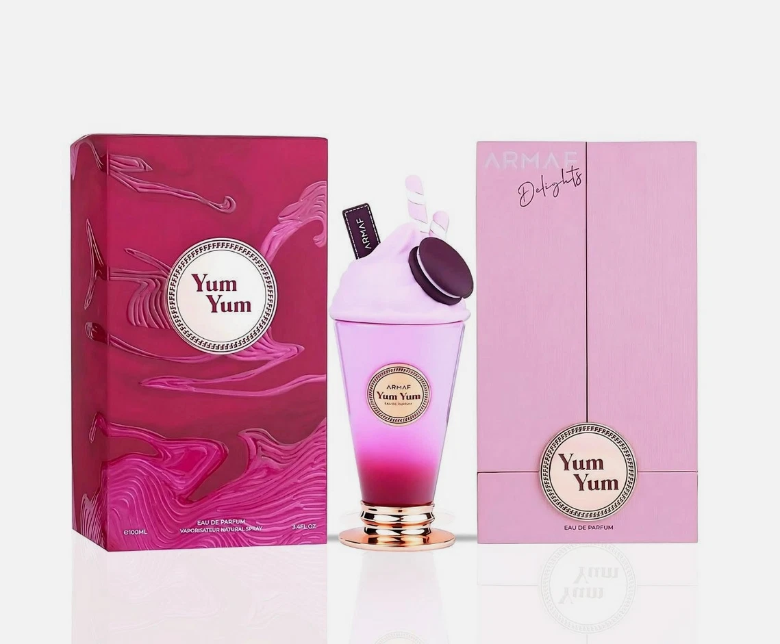 Frasco de perfume rosa e roxo Yum Yum com caixas vinho e rosa ao lado