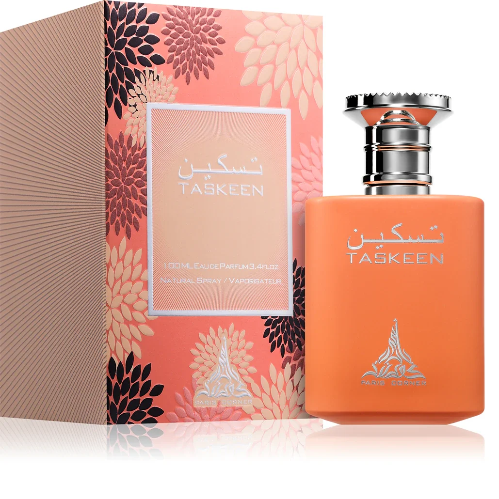 Frasco laranja fosco de perfume Taskeen com tampa prateada ao lado de caixa rosa floral