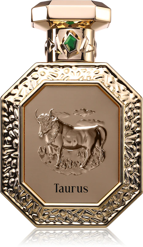 Frasco dourado de perfume Taurus com relevo de touro e pedra verde na tampa