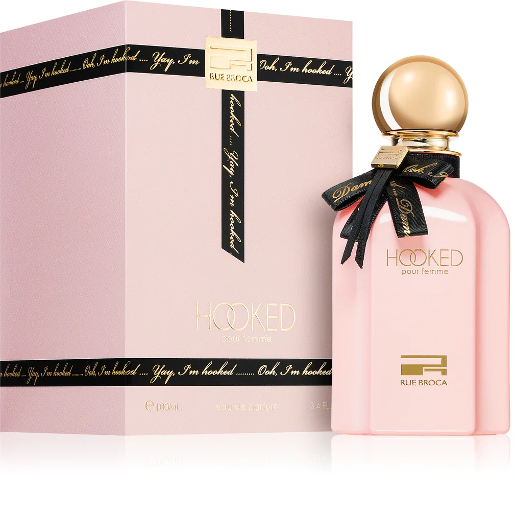 Frasco de perfume rosa e caixa rosa com texto dourado