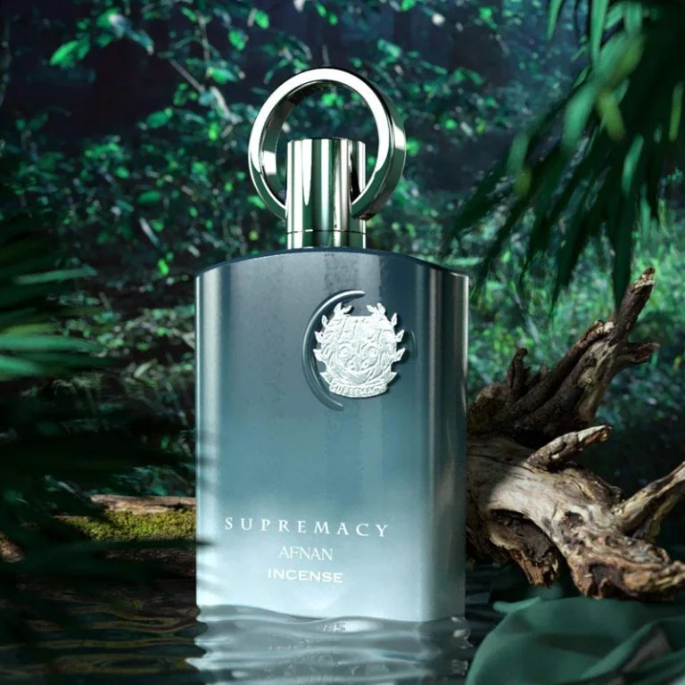Frasco de perfume metálico prateado SUPREMACY AFNAN INCENSE em fundo de floresta