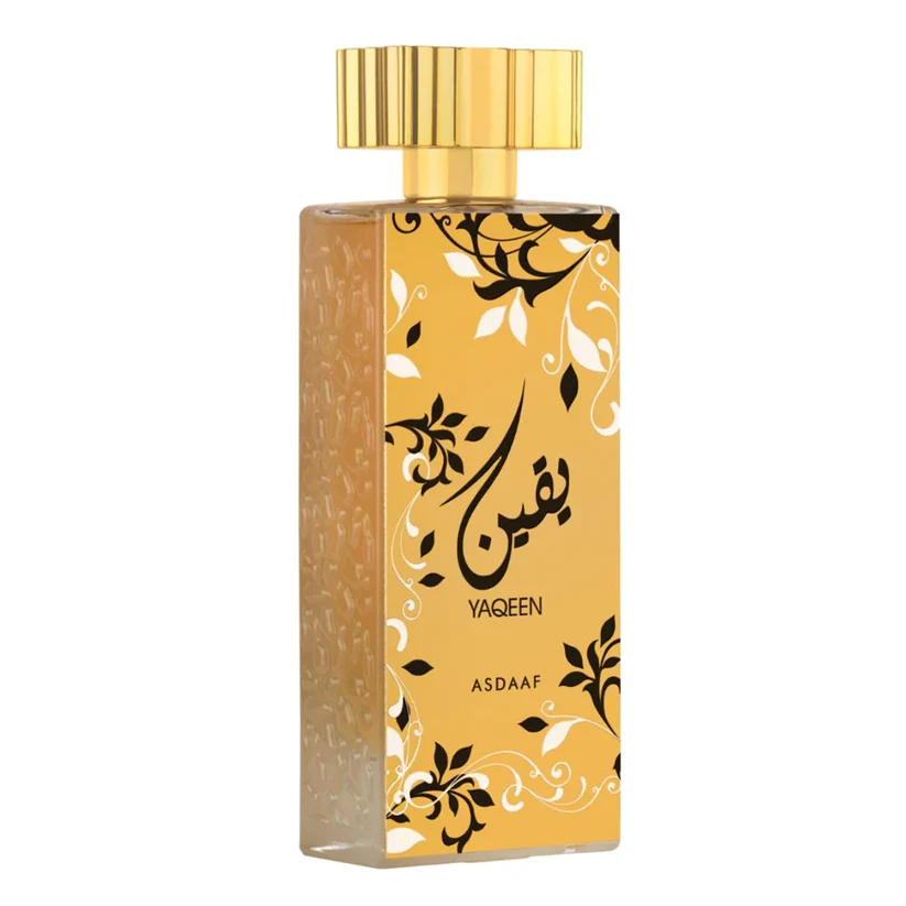 Frasco de perfume dourado com padrões florais e texto YAQEEN ASDAAF