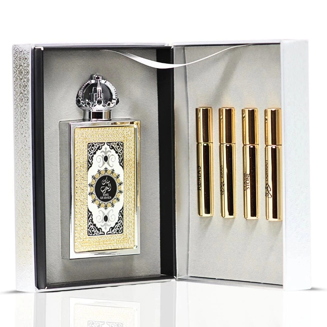 Conjunto de perfume com frasco decorativo e 4 frascos pequenos dourados numa caixa aberta