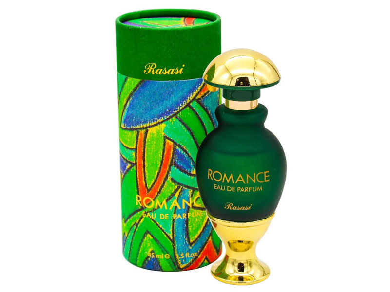 Frasco de perfume verde escuro com tampa e base douradas ao lado da embalagem cilíndrica colorida