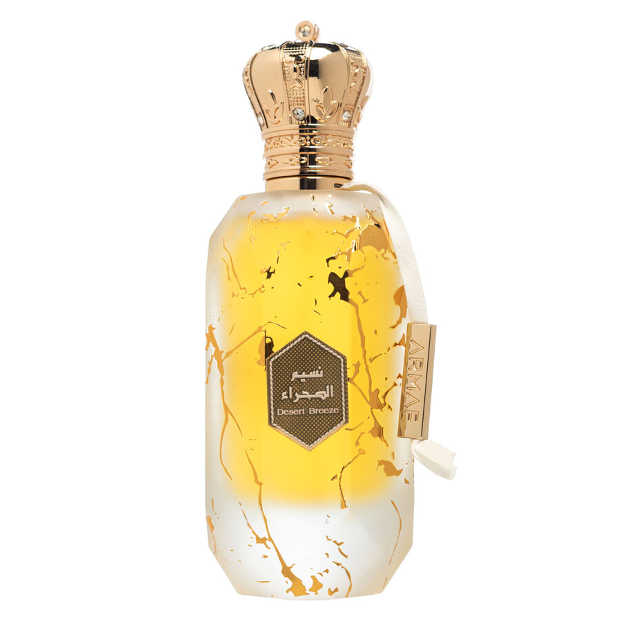 Frasco de perfume amarelo com tampa coroa dourada e etiquetas em árabe e inglês