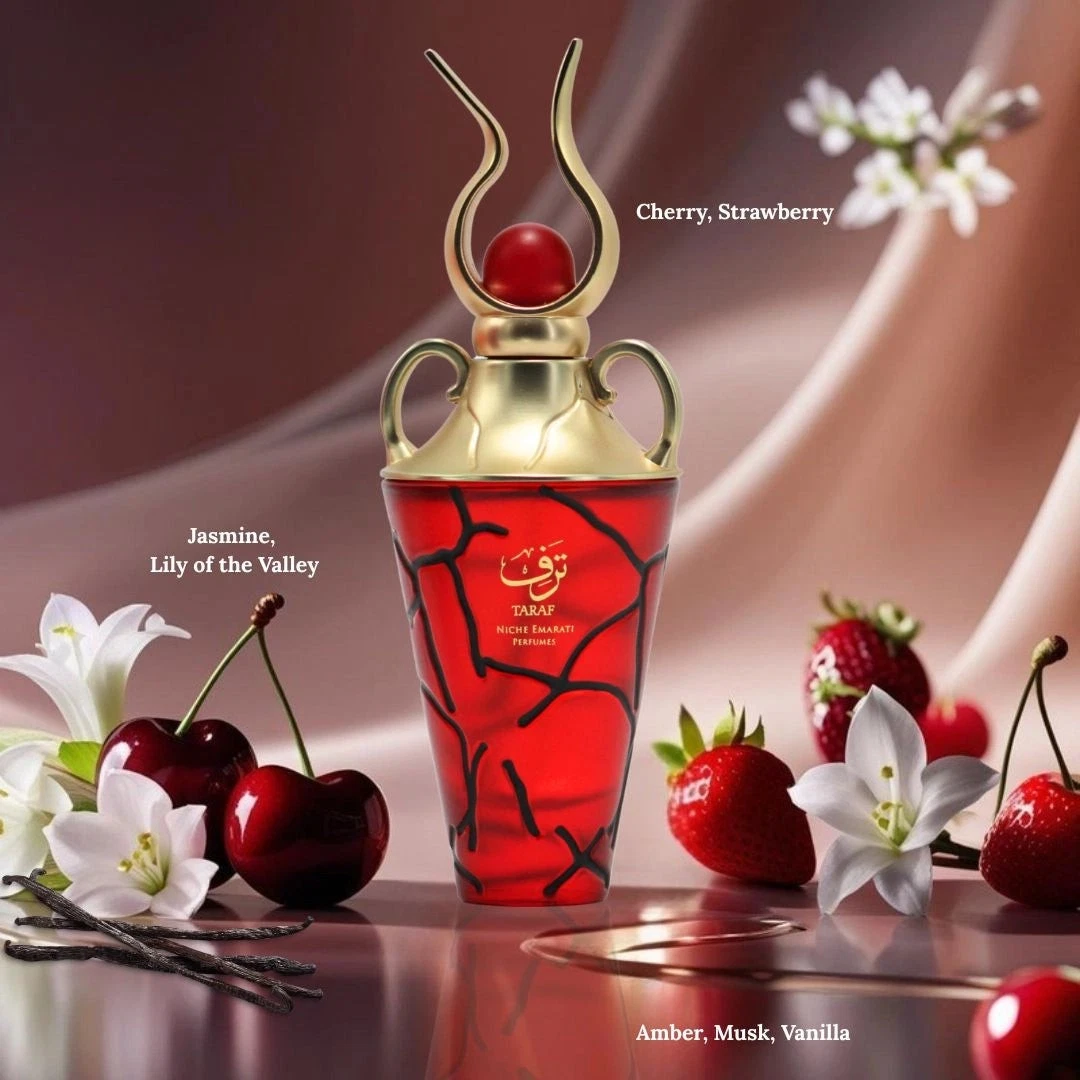 Frasco de perfume vermelho com tampa dourada e decoração floral e frutal ao redor