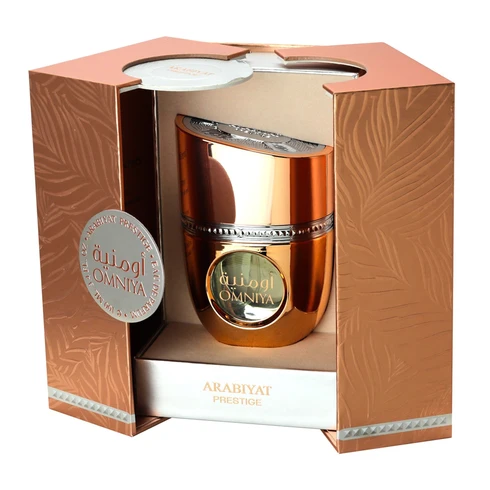 Frasco de perfume cobre metálico com caixa decorada em tons terrosos e texto Arabiyat Prestige