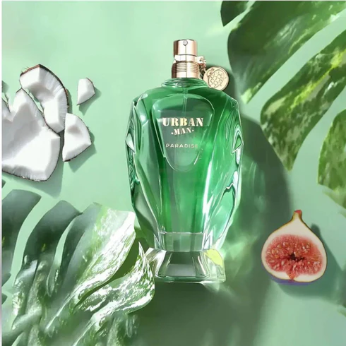 Frasco de perfume verde URBAN MAN PARADISE com folhas e frutas ao redor.