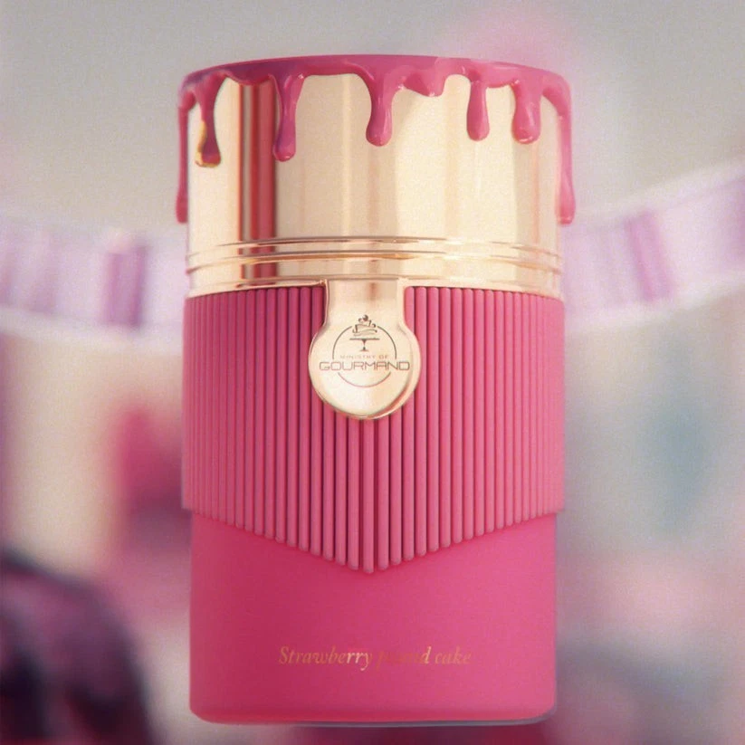 Frasco de perfume rosa com tampa dourada e decoração tipo gotejamento