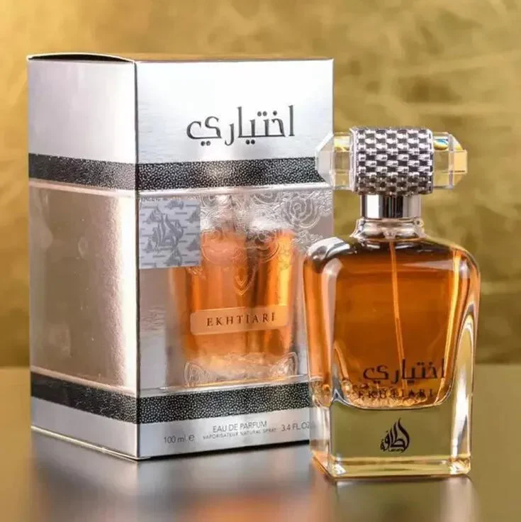 Frasco de perfume âmbar EKHTIARI com caixa prateada e branca