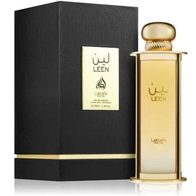 Frasco de perfume dourado com caixa preta texturizada