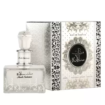 Frasco de perfume transparente com tampa branca ao lado de caixa branca decorada