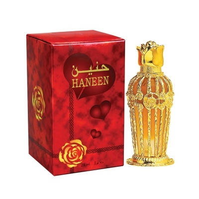 Frasco de perfume âmbar com tampa dourada e caixa vermelha decorada