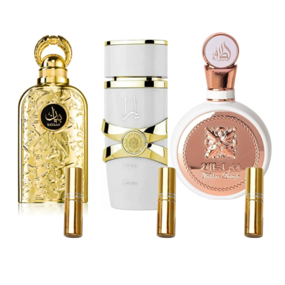 Três frascos de perfume com detalhes dourados e cobre cada um com vaporizador dourado