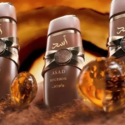 Frasco de perfume ASAD BOURBON da Lattafa com pedras alaranjadas