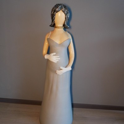 Estátua decorativa de mulher com vestido cinzento e luvas brancas