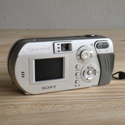 Câmara digital Sony Cyber-shot cinzenta prateada com ecrã LCD e botões