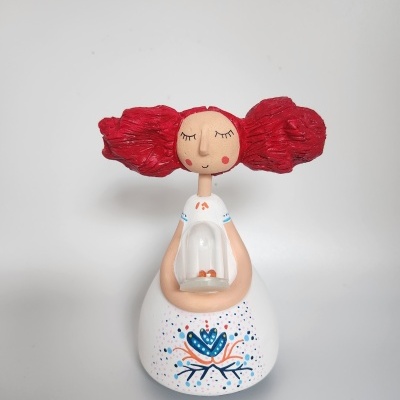 Boneca decorativa branca com padrão floral e cabelo vermelho