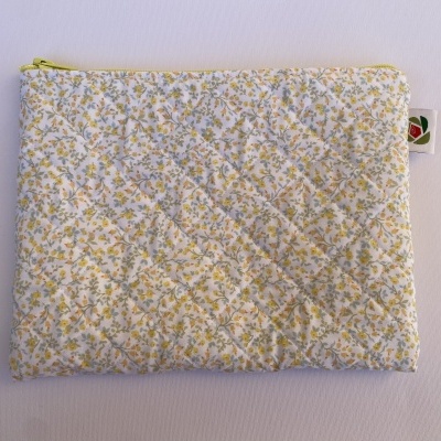 Estojo acolchoado com padrão floral amarelo e verde
