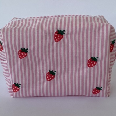 Necessaire rosa riscas verticais com estampas de morangos vermelhos e folhas verdes