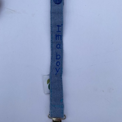 Clipe de chupeta azul claro com texto 'I'm a boy'