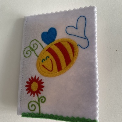 Capa branca com bordado de abelha, corações e flor