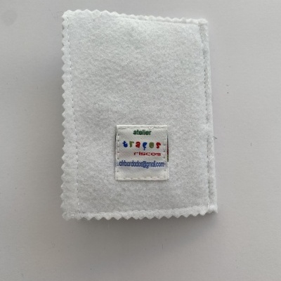 Produto de tecido branco com etiqueta colorida com texto sobre fundo claro