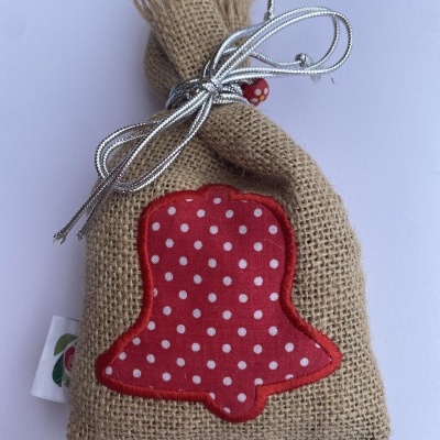 Saco de juta com aplicação vermelha de sino com bolinhas brancas e cordão prateado