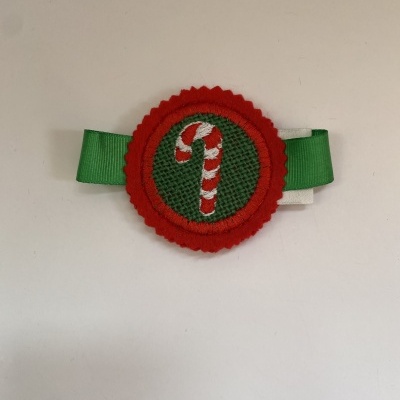 Laço verde com detalhe bordado de bastão de doces