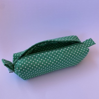 Estojo verde com bolinhas brancas e fecho de correr preto