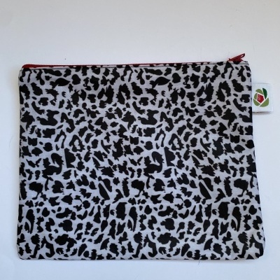 Estojo de tecido com padrão preto e branco e fecho vermelho