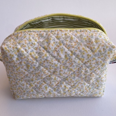 necessaire matelassada com padrão floral amarelo