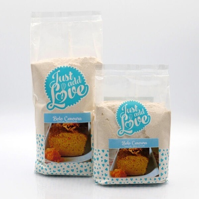 Pacotes transparentes de mistura para bolo de cenoura com etiquetas azuis e brancas