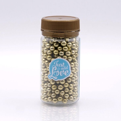 Frasco plástico transparente com esferas douradas e rótulo azul 'Just add Love'.