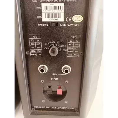 Parte traseira de equipamento áudio preto com etiquetas e conexões