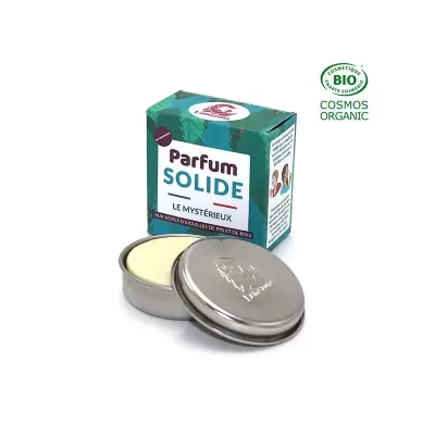 Perfume sólido em embalagem metálica com caixa verde orgânica.