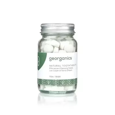 Frasco de vidro com pastilhas efervescentes para dentes, rótulo com marca georganics