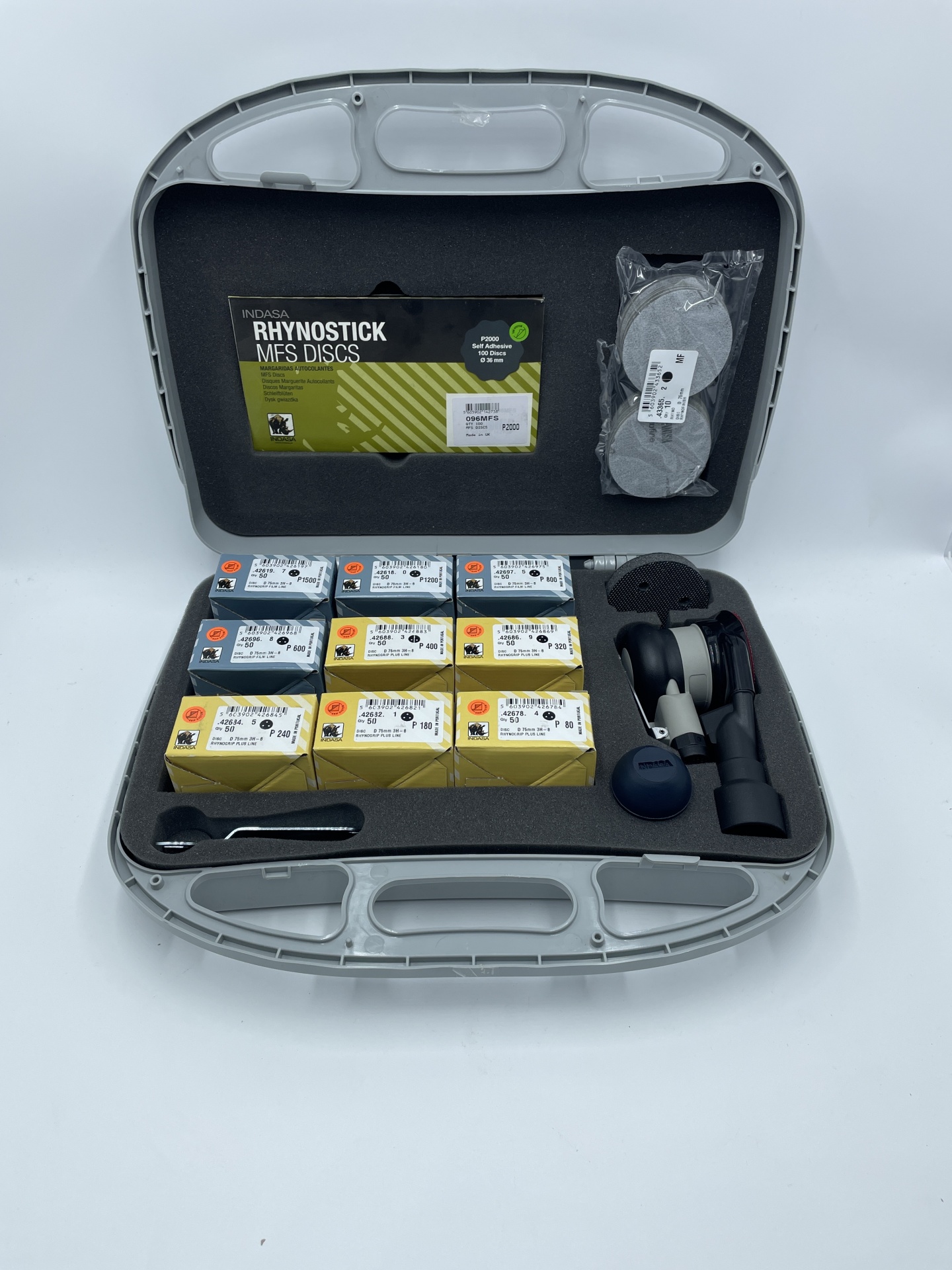 Estojo aberto com acessórios de polimento automóvel e discos Rhynostick MFS.