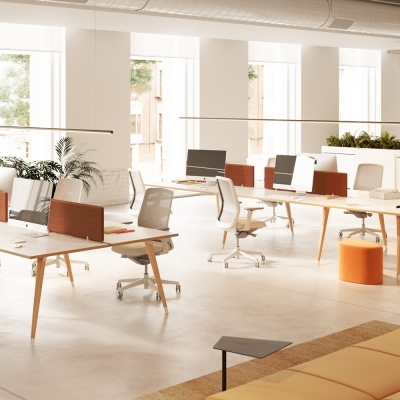 Escritório moderno com mesas, cadeiras brancas e divisórias laranja, plantas e luz natural