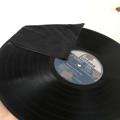 Disco de vinil preto com etiqueta azul e tecido preto