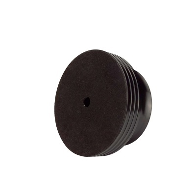 Disco preto com orifício central numa superfície branca