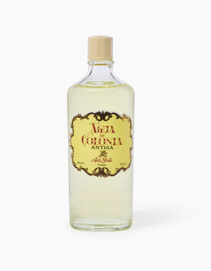Ach. Brito - Água de Colónia Antiga Frasco de água de colónia antiga transparente com rótulo amarelado e tampa bege