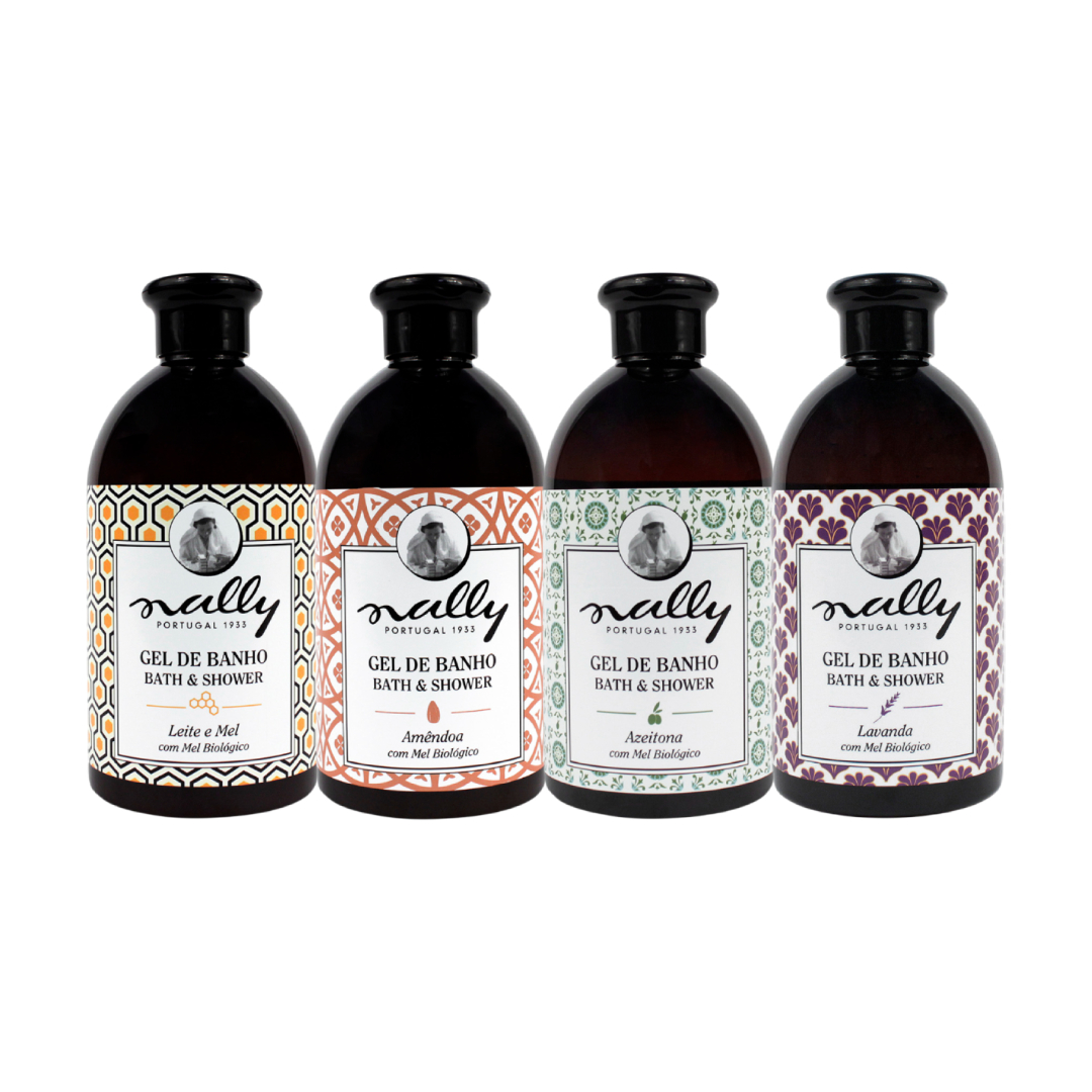 Nally - Gel de Banho Quatro frascos castanhos de gel de banho Nally com diferentes fragrâncias e rótulos coloridos.