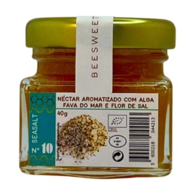 Frasco de vidro com tampa metálica verde contendo néctar aromatizado com alga fava do mar e flor de sal