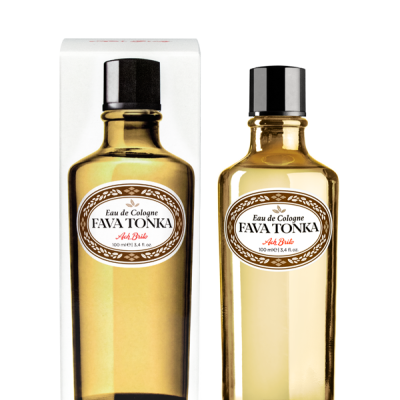 Garrafa de vidro âmbar de Eau de Cologne FAVA TONKA ao lado da sua caixa branca com a imagem da garrafa