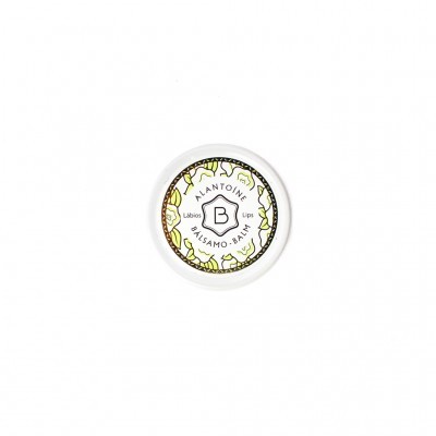 Pote branco de bálsamo labial com tampa decorada e texto central.