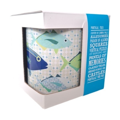 Caneca decorada com peixes coloridos dentro de caixa branca e azul com texto
